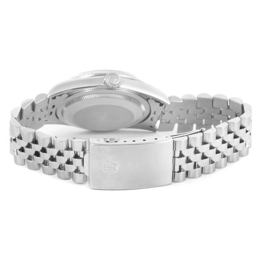 The image shows the backside of a Rolex Datejust 16234 Men's Stainless Steel White Dial 16234 Men's Stainless Steel White Dial watch along with its metal bracelet and clasp.