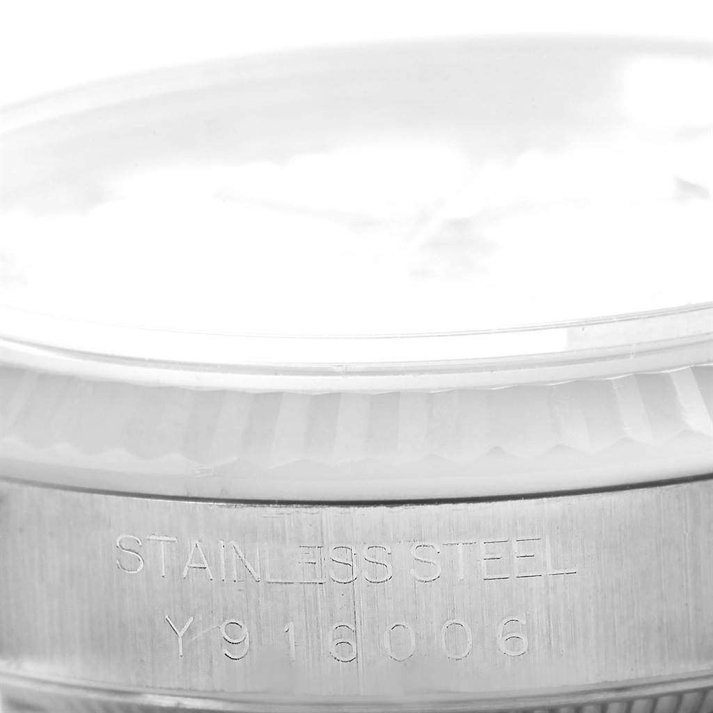 This image shows a close-up side view of a Rolex Datejust 16234 Men's Stainless Steel White Dial 16234 Men's Stainless Steel White Dial watch, focusing on its stainless steel casing with a visible serial number.