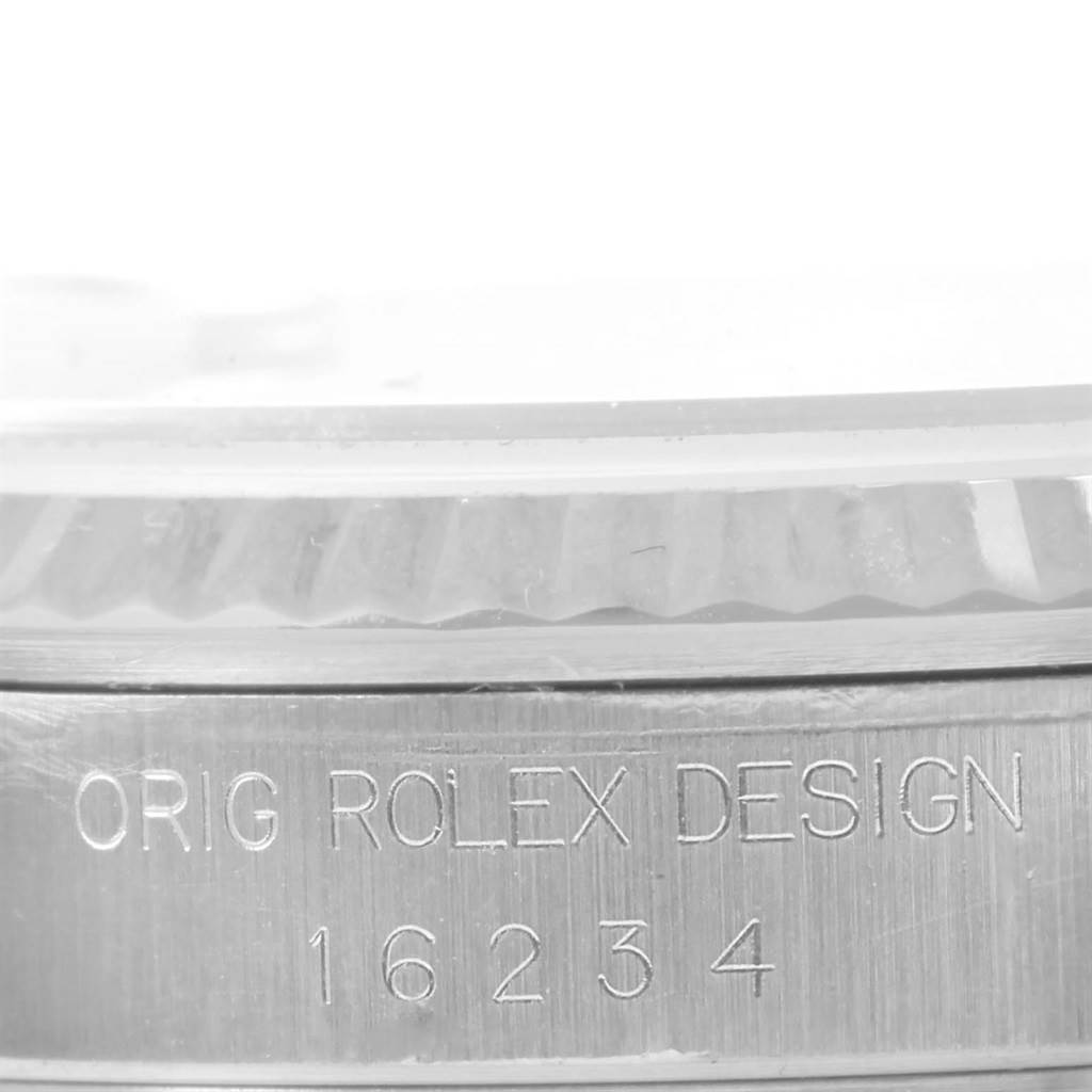 This image shows a close-up angle of the case side of a Rolex Datejust 16234 Men's Stainless Steel Silver Dial 16234 Men's Stainless Steel Silver Dial, featuring the etched "ORIG ROLEX DESIGN 16234".