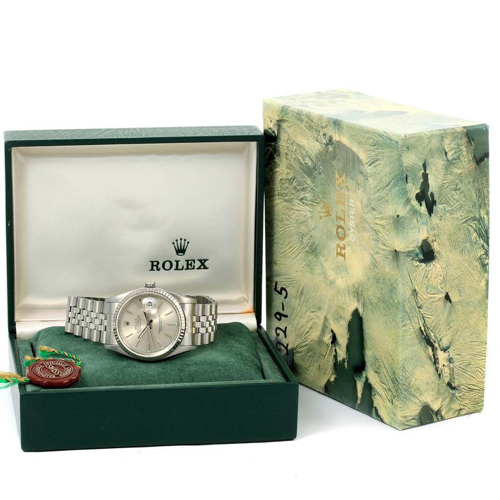 This image shows a Rolex Datejust 16234 Men's Stainless Steel Silver Dial 16234 Men's Stainless Steel Silver Dial watch inside an open box, accompanied by its outer packaging on the right.
