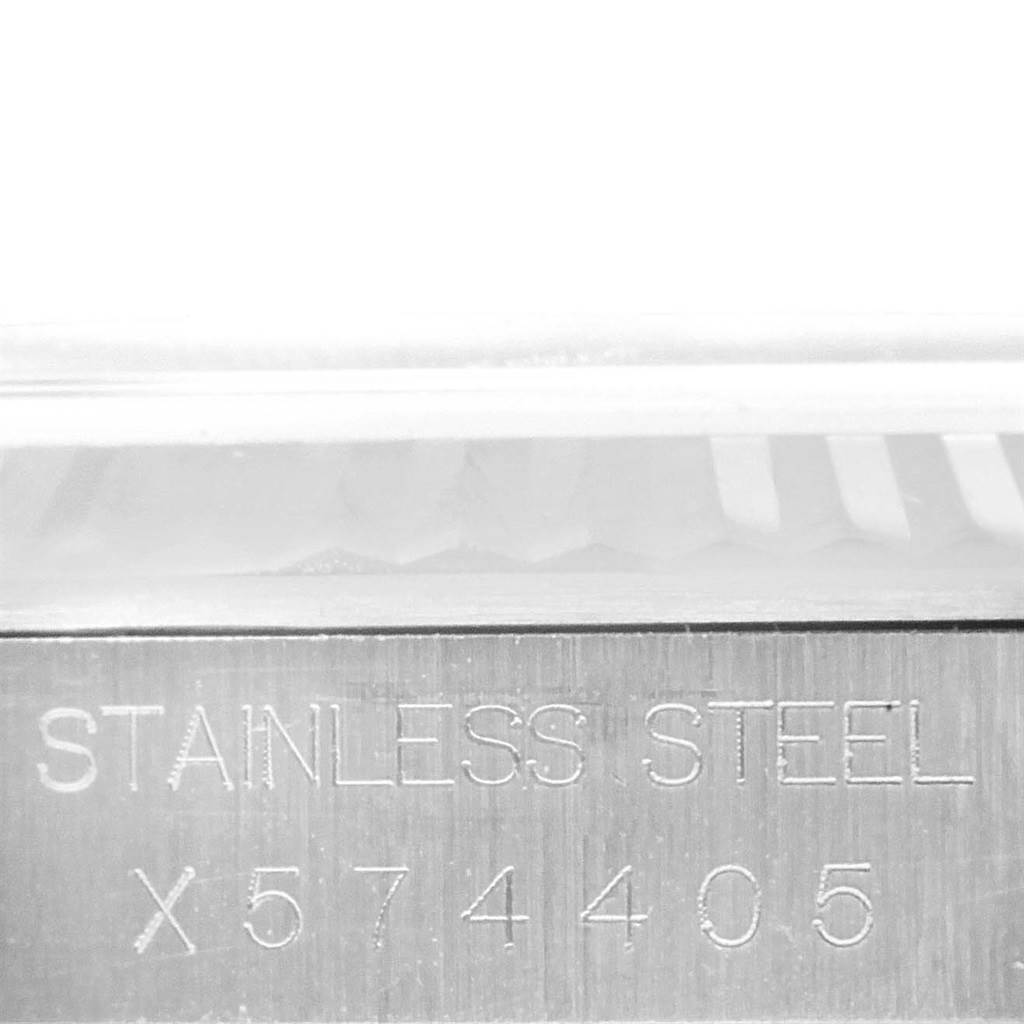 This image shows a close-up of the casing side with the serial number and "STAINLESS STEEL" engraving of a Rolex Datejust 16234 Men's Stainless Steel Silver Dial 16234 Men's Stainless Steel Silver Dial watch.