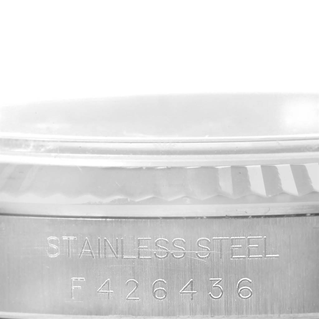 This image shows a close-up of the serial number and "STAINLESS STEEL" marking on the side of a Rolex Datejust 16234 Men's Stainless Steel White Dial 16234 Men's Stainless Steel White Dial watch case.