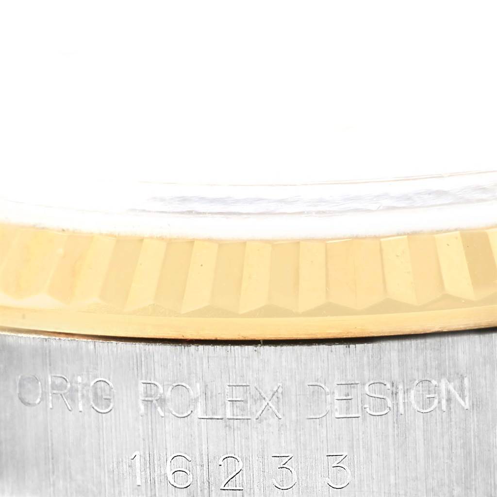 This image shows a close-up of the bezel and case side with an engraved serial number of a Rolex Datejust 16233 Steel and Gold (two tone) White Dial 16233 Steel and Gold (two tone) White Dial model.