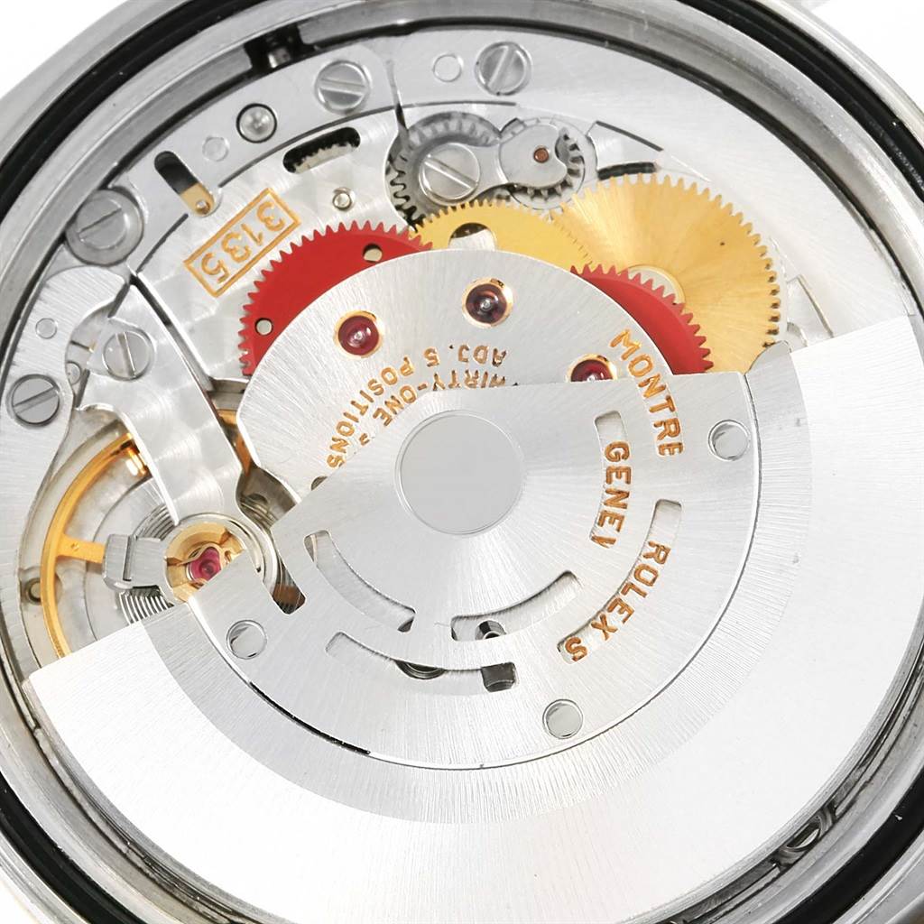 The image shows the internal mechanical movement of a Rolex Datejust 16233 Steel and Gold (two tone) White Dial 16233 Steel and Gold (two tone) White Dial watch, highlighting gears and intricate details.