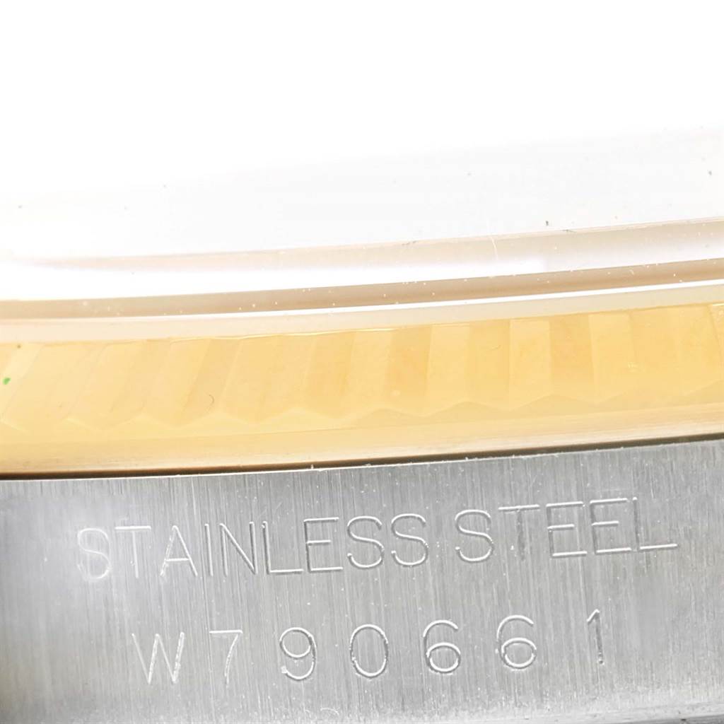 This is a close-up of the side of a Rolex Datejust 16233 Steel and Gold (two tone) Champagne Dial 16233 Steel and Gold (two tone) Champagne Dial watch, showing the stainless steel part with an engraved serial number.