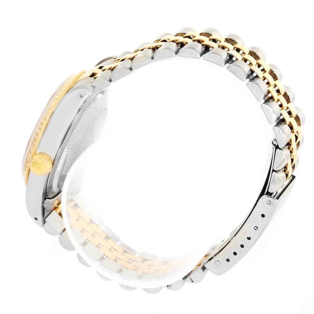 This image shows a Rolex Datejust 16233 Steel and Gold (two tone) Champagne Dial 16233 Steel and Gold (two tone) Champagne Dial watch from a side angle, highlighting its two-tone bracelet and crown.