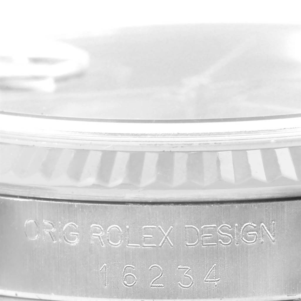 This image shows a close-up of the bezel and engraved serial number on the case side of a Rolex Datejust 16234 Men's Stainless Steel Blue Dial 16234 Men's Stainless Steel Blue Dial watch.