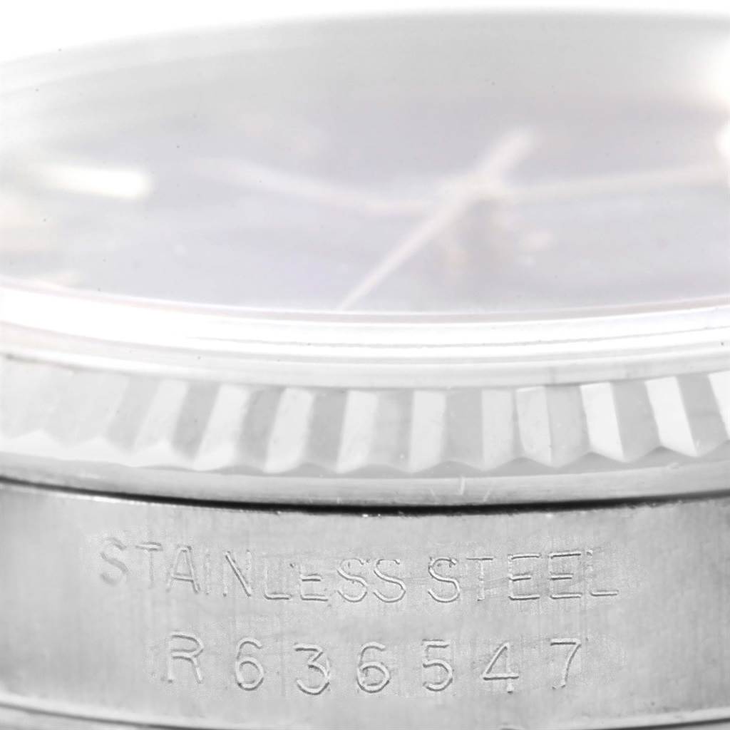The image shows a close-up side view of the bezel, dial, and engraving on the Rolex Datejust 16234 Men's Stainless Steel Blue Dial 16234 Men's Stainless Steel Blue Dial watch in stainless steel.
