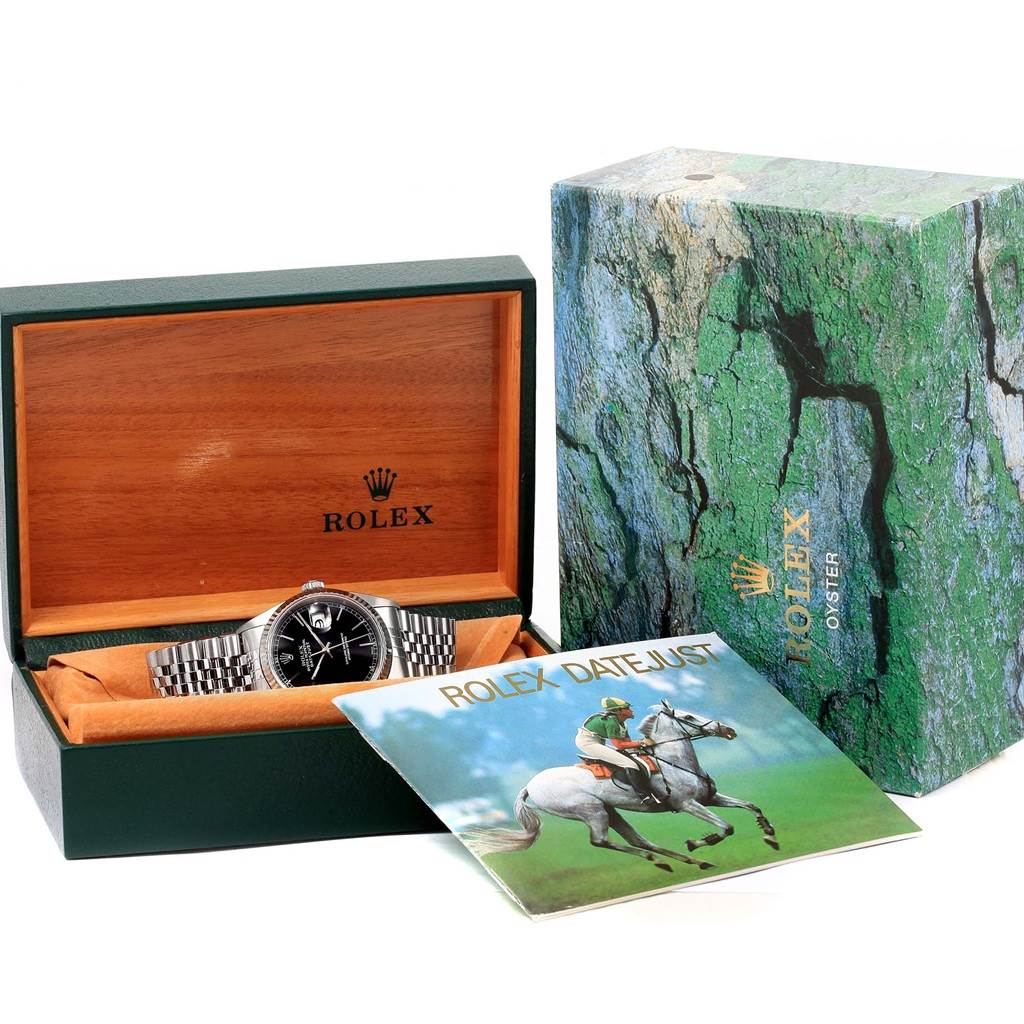 The Rolex Datejust 16234 Men's Stainless Steel Black Dial 16234 Men's Stainless Steel Black Dial watch is shown in its open box with its booklet and outer packaging visible.