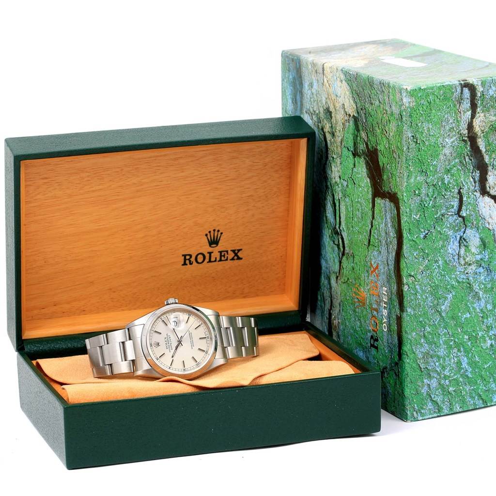 The Rolex Datejust 16200 Men's Stainless Steel Silver Dial 16200 Men's Stainless Steel Silver Dial watch is displayed in its open box with the packaging visible beside it, showing part of the bracelet and dial.