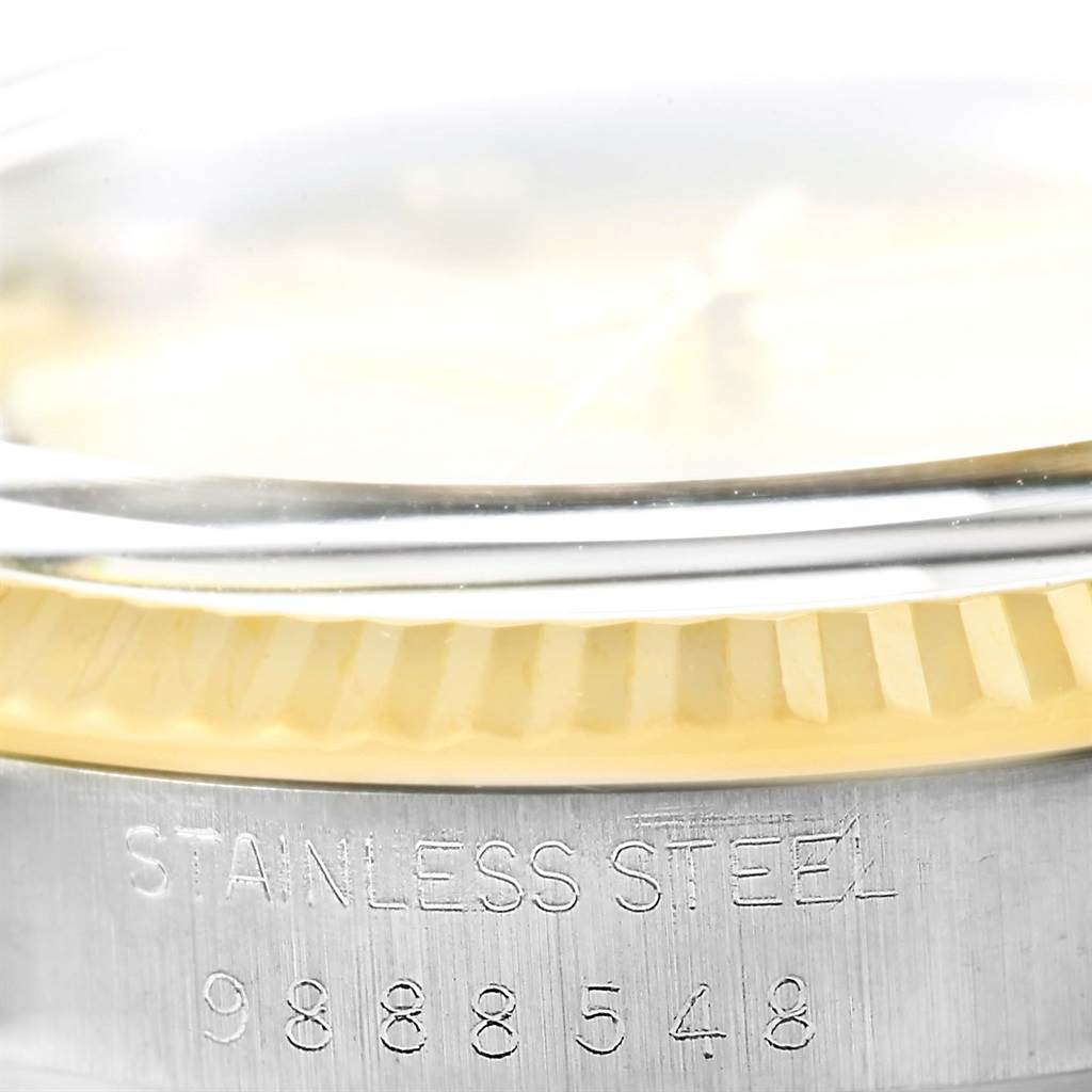 This image shows a close-up of the case side and fluted bezel of a Rolex Datejust 16013 Stainless Steel Champagne Dial 16013 Stainless Steel Champagne Dial, highlighting the serial number engraving.