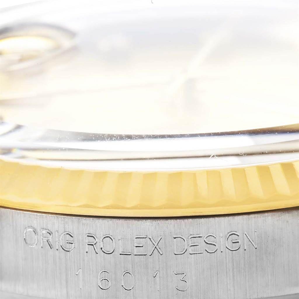 This close-up shot of the Rolex Datejust 16013 Stainless Steel Champagne Dial 16013 Stainless Steel Champagne Dial watch shows the side of the case, bezel, and part number 16013.