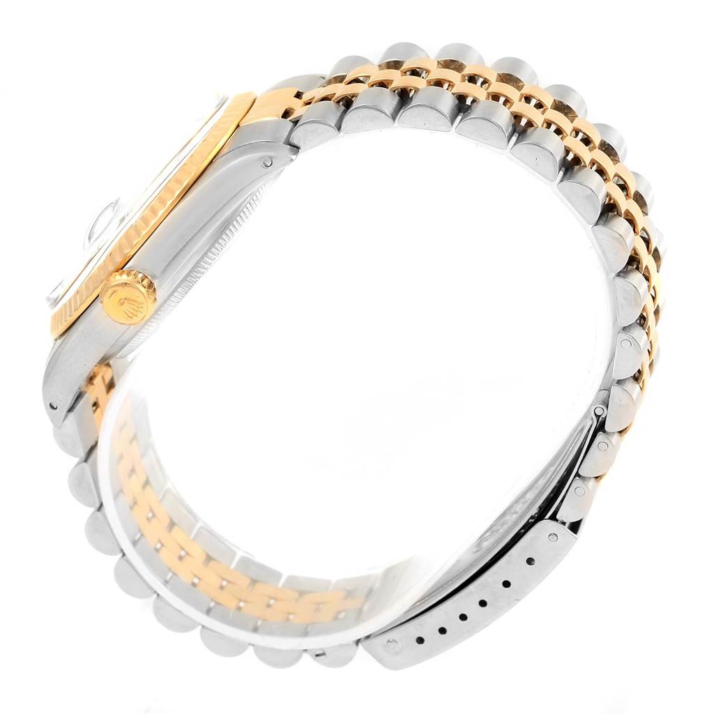 This side profile view of the Rolex Datejust 16013 Stainless Steel Champagne Dial 16013 Stainless Steel Champagne Dial watch shows the case, crown, and two-tone bracelet.