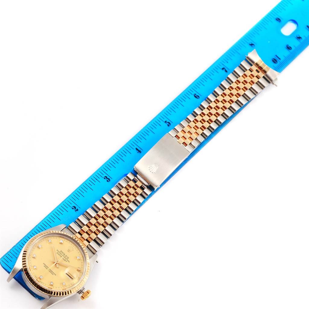 This image shows a top-down view of a Rolex Datejust 16013 Men's Stainless Steel Champagne Dial 16013 Men's Stainless Steel Champagne Dial watch, highlighting the dial, bracelet, clasp, and a ruler for scale.