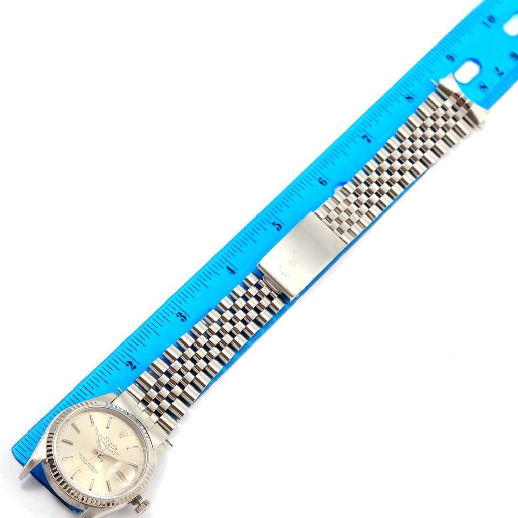 The image shows the Rolex Datejust 16234 Men's Stainless Steel Silver Dial 16234 Men's Stainless Steel Silver Dial watch laid flat with its full strap measured against a blue ruler.