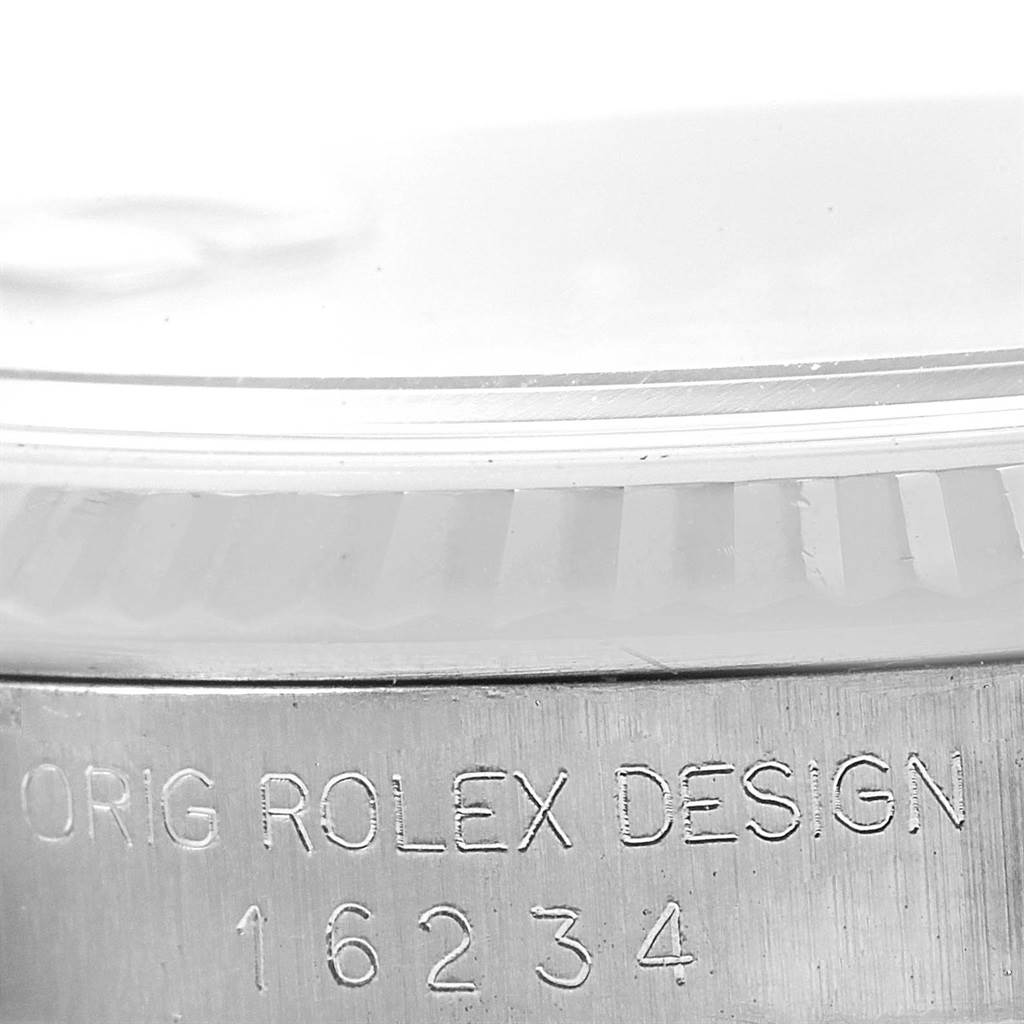 This close-up image shows the side engraving and part of the bezel of a Rolex Datejust 16234 Men's Stainless Steel Silver Dial 16234 Men's Stainless Steel Silver Dial model.