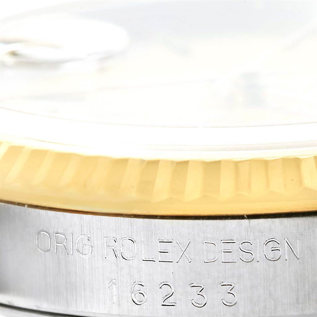 The image shows a close-up of the case side of the Rolex Datejust 16233 Men's Steel and Gold (two tone) Champagne Dial 16233 Men's Steel and Gold (two tone) Champagne Dial, highlighting the bezel and engraved model number.