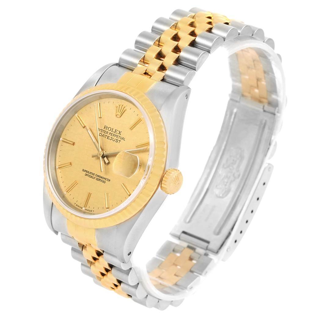 The Rolex Datejust 16233 Men's Steel and Gold (two tone) Champagne Dial 16233 Men's Steel and Gold (two tone) Champagne Dial watch is shown from an angled side view, highlighting the gold dial, fluted bezel, and two-tone bracelet.