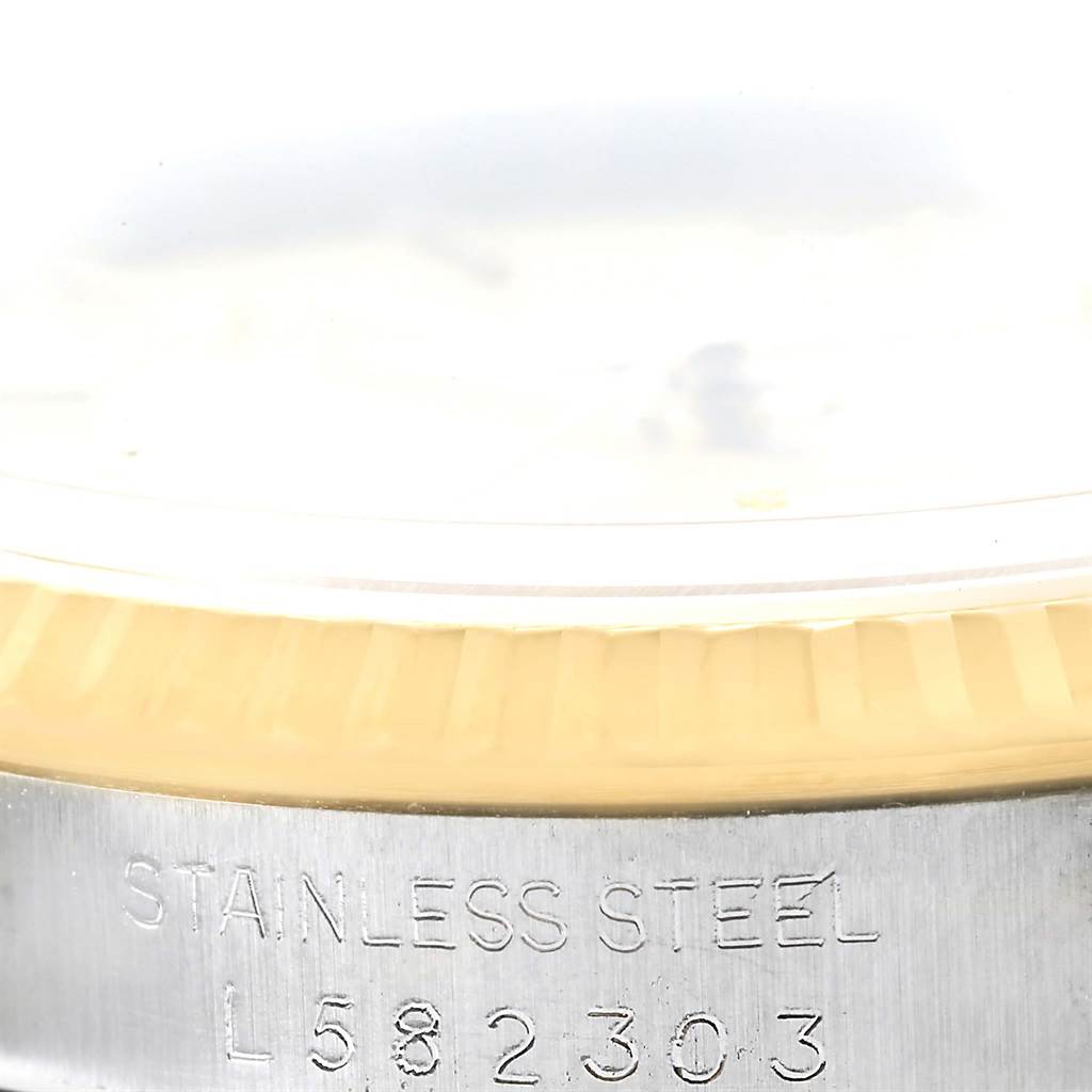 The image shows a partial view of the case back and fluted bezel of a Rolex Datejust 16233 Men's Steel and Gold (two tone) Champagne Dial 16233 Men's Steel and Gold (two tone) Champagne Dial watch, with the serial number inscribed.