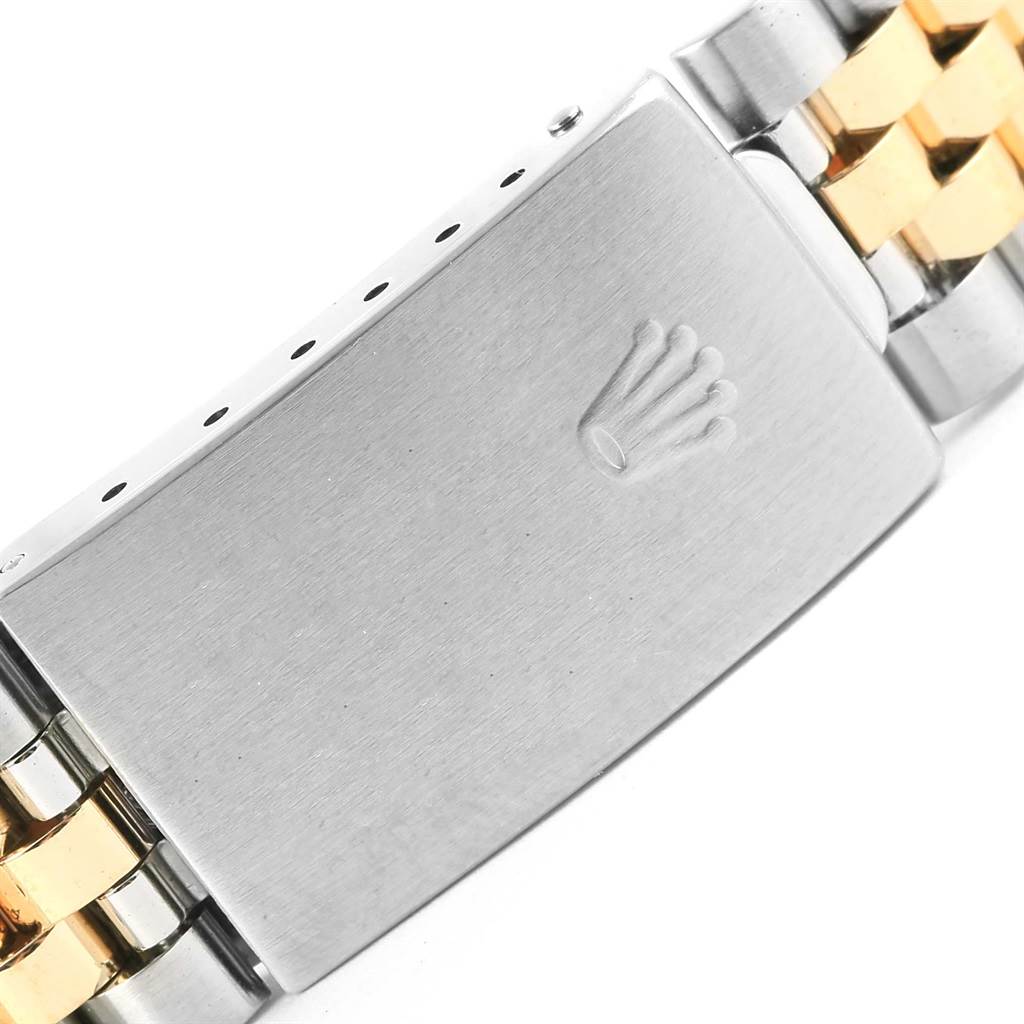 This image shows a close-up of the clasp on a Datejust model by Rolex, highlighting the bi-metal bracelet and engraved logo.