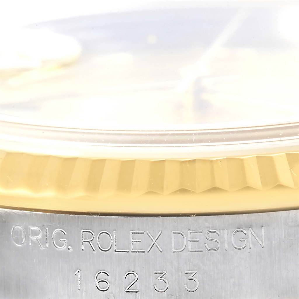 This image shows a close-up of the bezel and case with "ORIG. ROLEX DESIGN" and model number 16233 of a Rolex Datejust 16233 Men's Steel and Gold (two tone) Champagne Dial 16233 Men's Steel and Gold (two tone) Champagne Dial.
