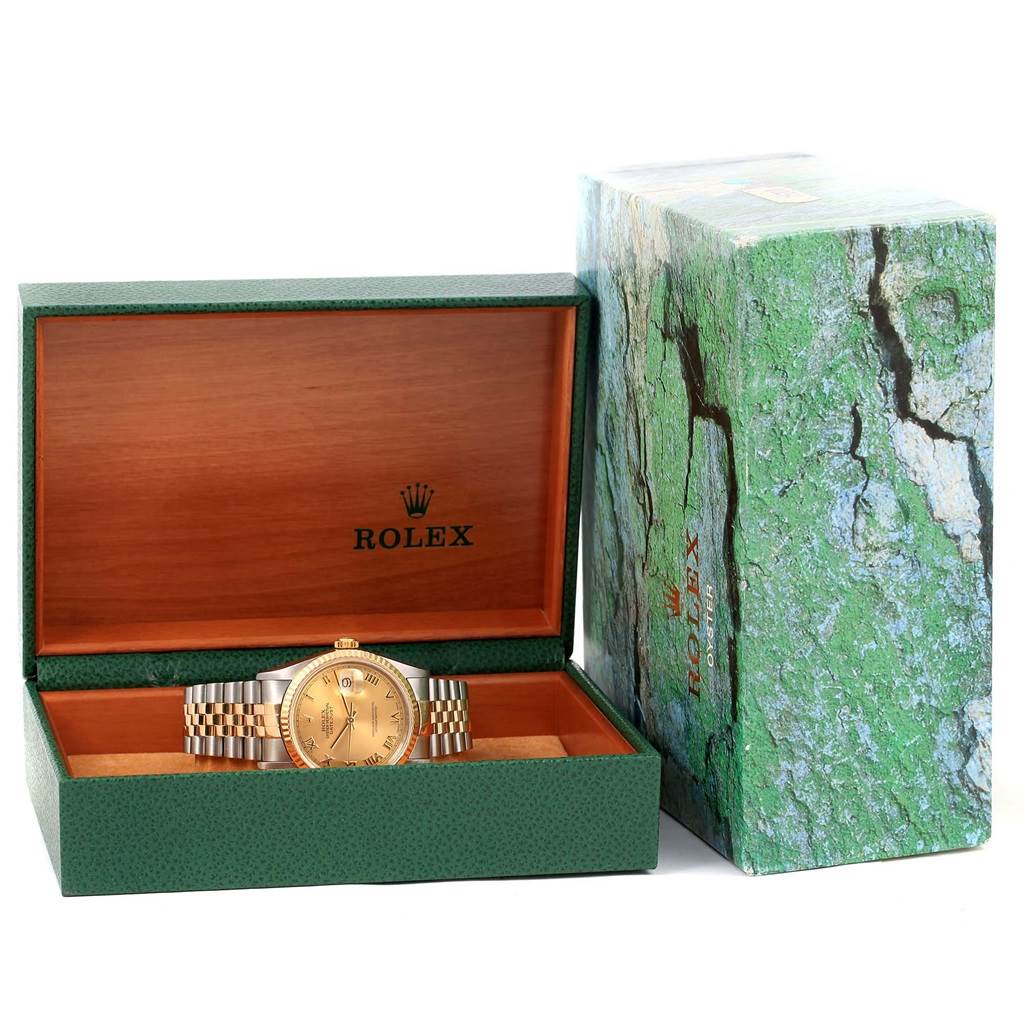 The image shows a Rolex Datejust 16233 Men's Steel and Gold (two tone) Champagne Dial 16233 Men's Steel and Gold (two tone) Champagne Dial watch displayed in an open green and wooden box, with the outer green box beside it.