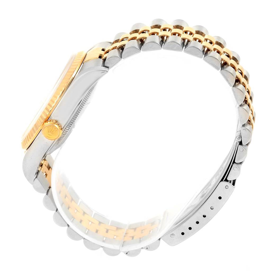 The image displays a side view of a Rolex Datejust 16233 Men's Steel and Gold (two tone) Champagne Dial 16233 Men's Steel and Gold (two tone) Champagne Dial watch, highlighting the two-tone bracelet and crown.