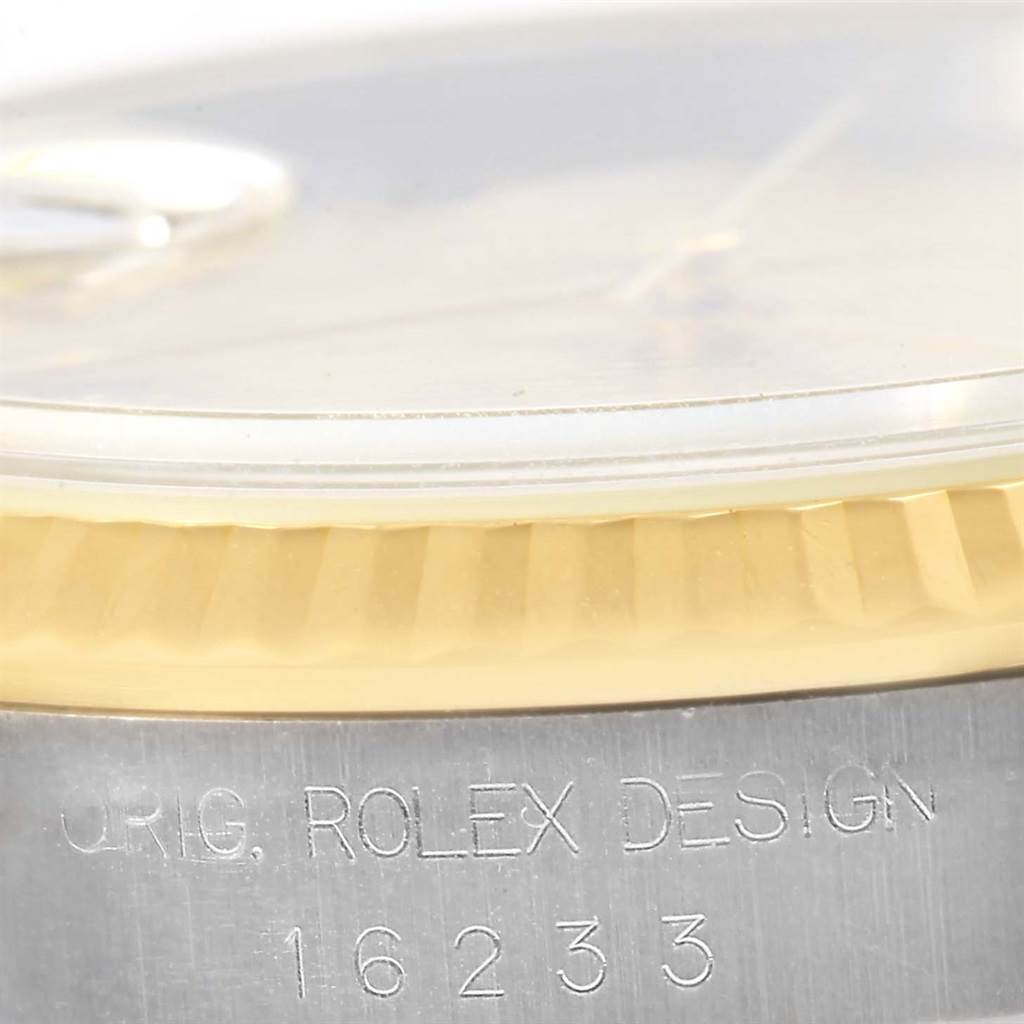 This close-up angle shows the side of the Rolex Datejust 16233 Men's Steel and Gold (two tone) Beige Dial 16233 Men's Steel and Gold (two tone) Beige Dial watch case with the model number 16233 and "ROLEX DESIGN" engraving.