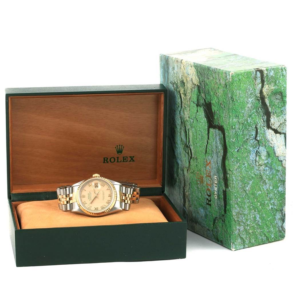 The image shows a Rolex Datejust 16233 Men's Steel and Gold (two tone) Beige Dial 16233 Men's Steel and Gold (two tone) Beige Dial watch placed inside an open Rolex box with its outer green-themed packaging displayed next to it.