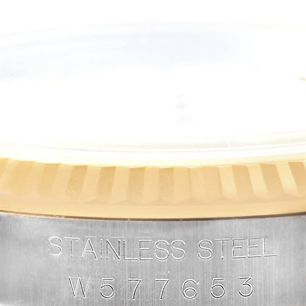 The image shows a close-up of the fluted bezel and part of the case with the serial number of a Rolex Datejust 16233 Men's Steel and Gold (two tone) Beige Dial 16233 Men's Steel and Gold (two tone) Beige Dial watch.