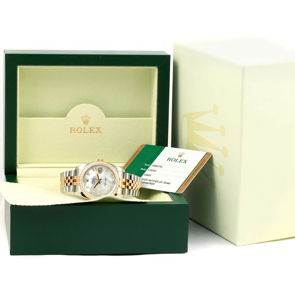 The image shows a Rolex Datejust 116243 Women's Stainless Steel Mother of Pearl Dial 116243 Women's Stainless Steel Mother of Pearl Dial watch in an open box, accompanied by a tag with model details and part of the outer packaging.