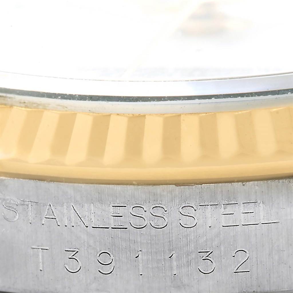 Close-up view of the side of a Rolex Datejust 16233 Men's Steel and Gold (two tone) White Dial 16233 Men's Steel and Gold (two tone) White Dial watch, showing the fluted bezel and part of the stainless steel case.