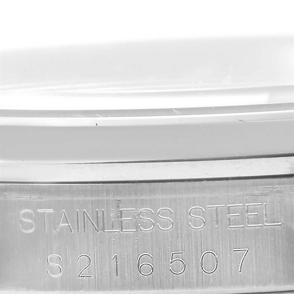 The image shows a close-up of the stainless steel case back of a Rolex Datejust 16200 Men's Stainless Steel Silver Dial 16200 Men's Stainless Steel Silver Dial, highlighting the engraved serial number.