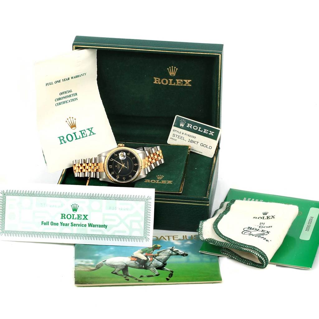 The image shows a Rolex Datejust 16233 Men's Steel and Gold (two tone) Black Dial 16233 Men's Steel and Gold (two tone) Black Dial watch and its accessories including the box, warranty card, manual, and cloth, viewed from the front.