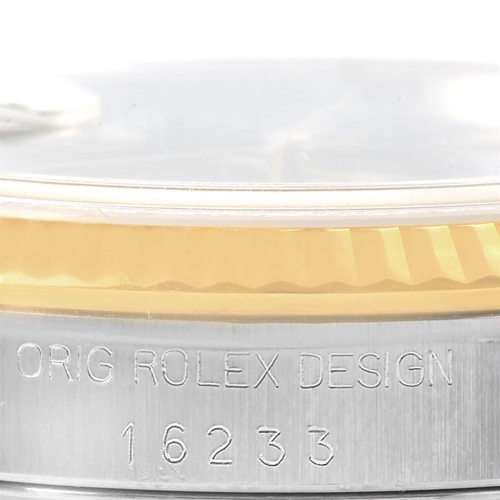 This image shows a close-up of the side of a Rolex Datejust 16233 Men's Steel and Gold (two tone) Black Dial 16233 Men's Steel and Gold (two tone) Black Dial watch, focusing on the engraved model number and design details.