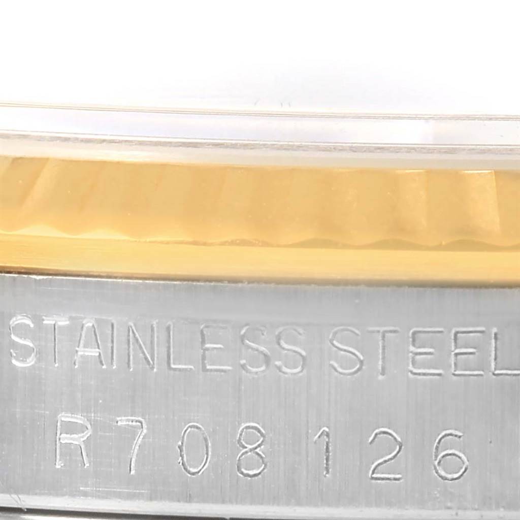 The image shows a close-up of the Rolex Datejust 16233 Men's Steel and Gold (two tone) Black Dial 16233 Men's Steel and Gold (two tone) Black Dial case with "stainless steel" and the model number engraved.