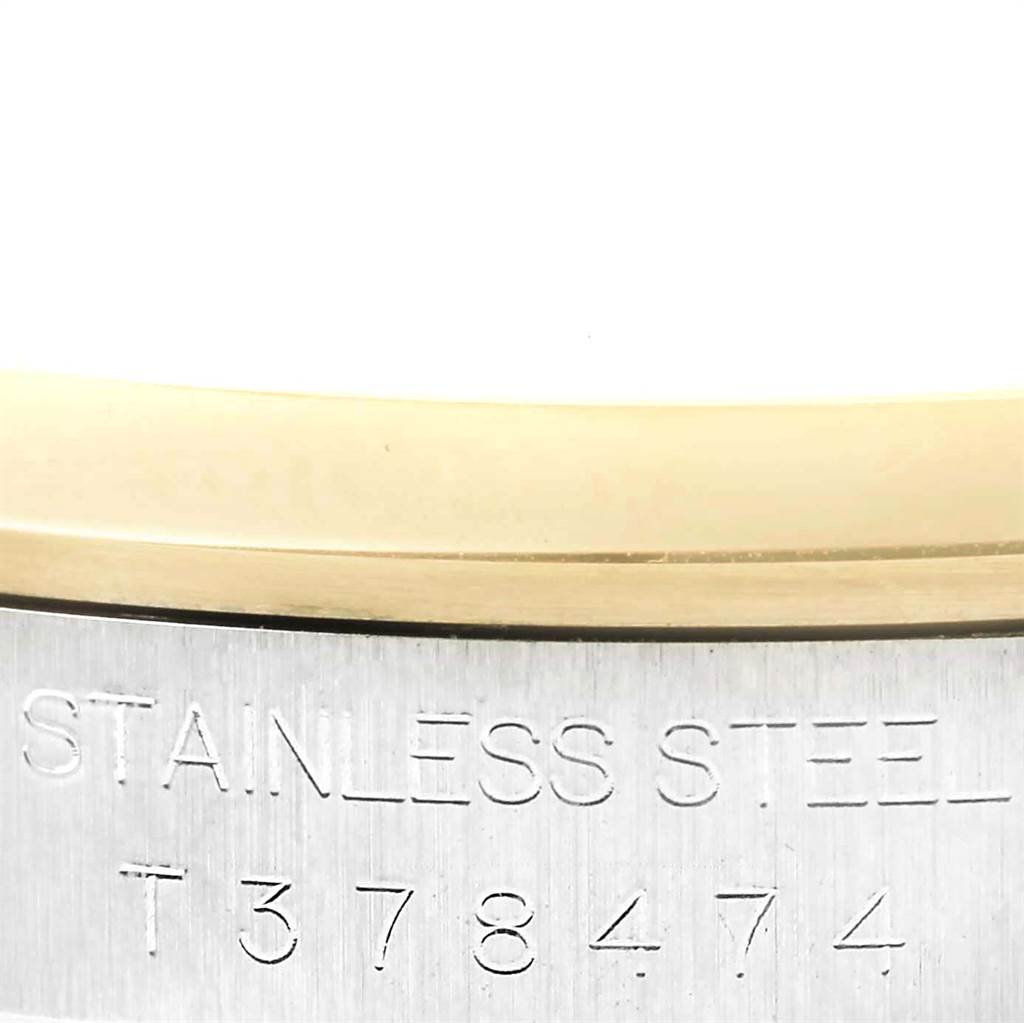 The image shows a close-up of the side of a Rolex Datejust 16203 Men's Steel and Gold (two tone) Beige Dial 16203 Men's Steel and Gold (two tone) Beige Dial, focusing on the stainless steel casing and serial number.