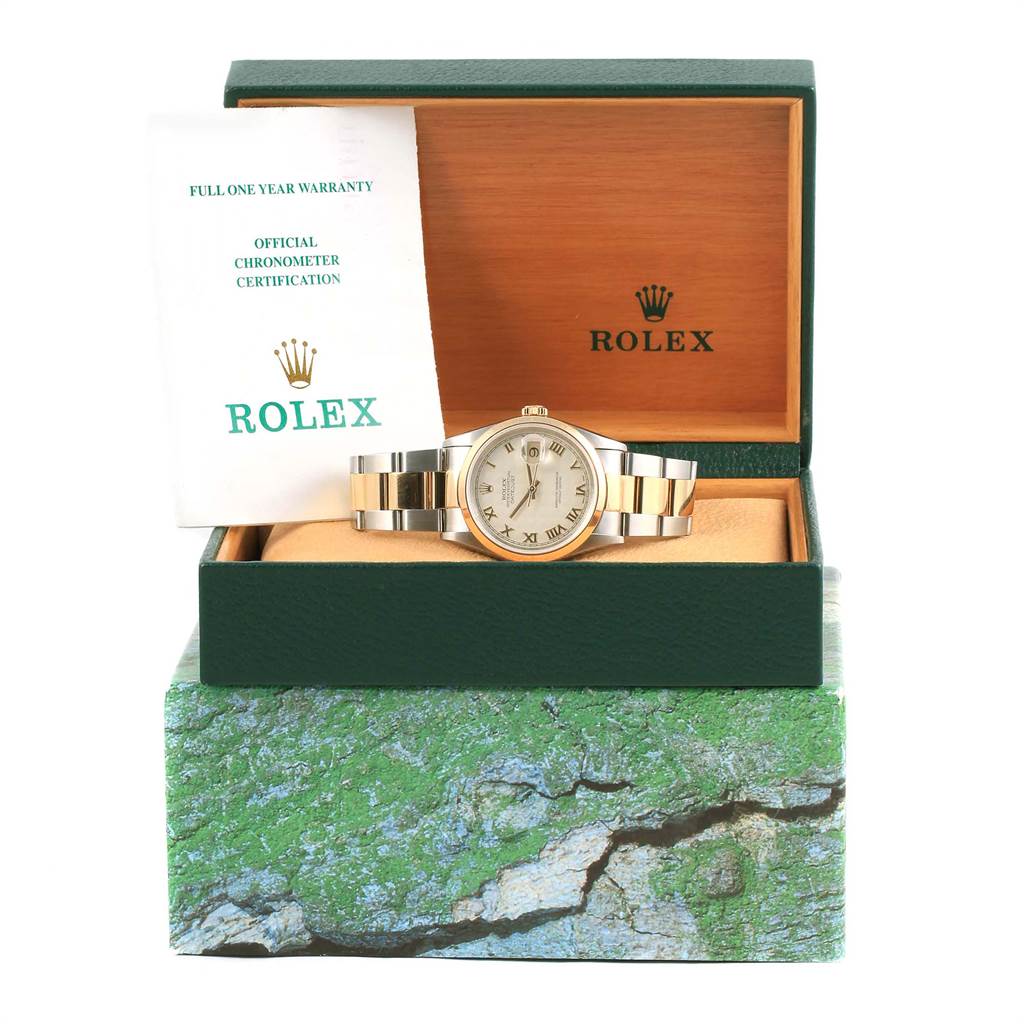 The Rolex Datejust 16203 Men's Steel and Gold (two tone) Beige Dial 16203 Men's Steel and Gold (two tone) Beige Dial watch is shown from the front in an open green and wood box, accompanied by warranty and certification documents.
