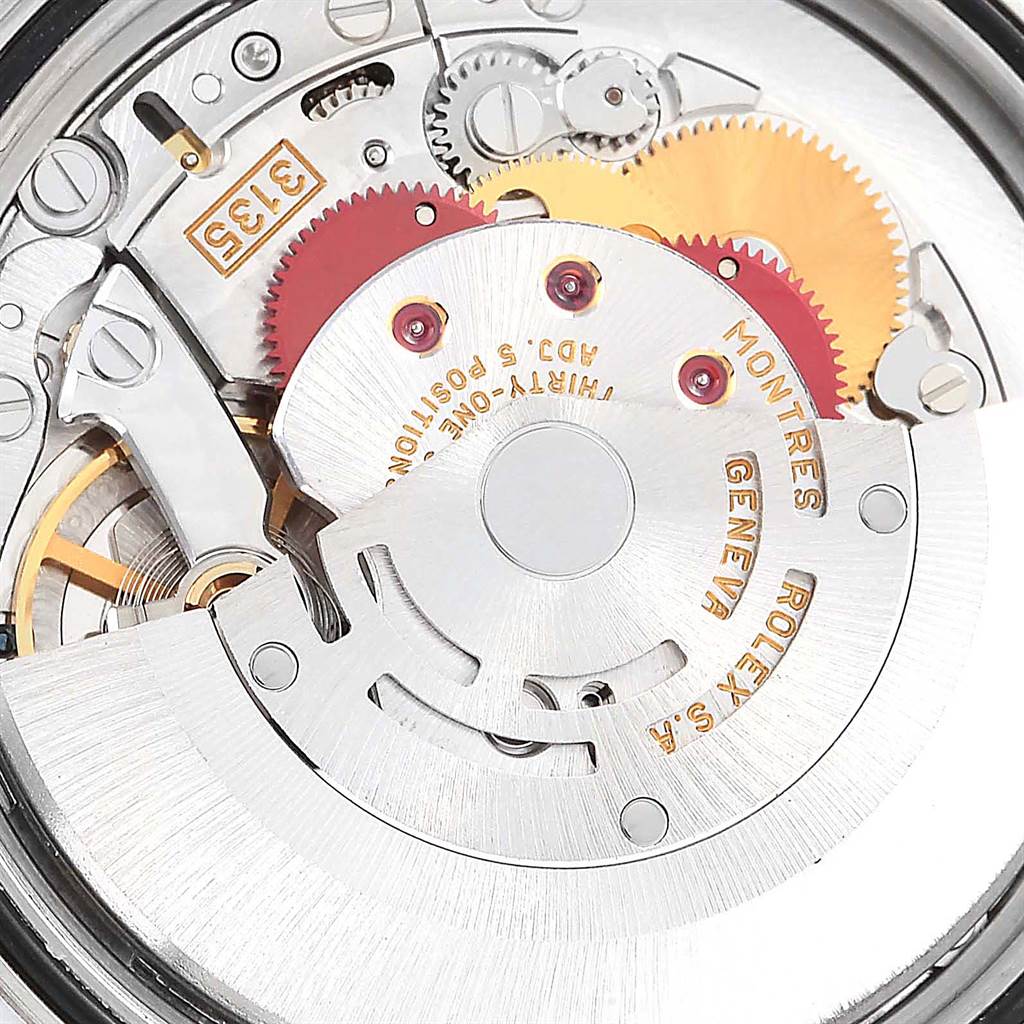 This image shows a close-up view of the mechanical movement inside a Rolex Datejust 16203 Men's Steel and Gold (two tone) Beige Dial 16203 Men's Steel and Gold (two tone) Beige Dial watch, featuring gears and intricate components.
