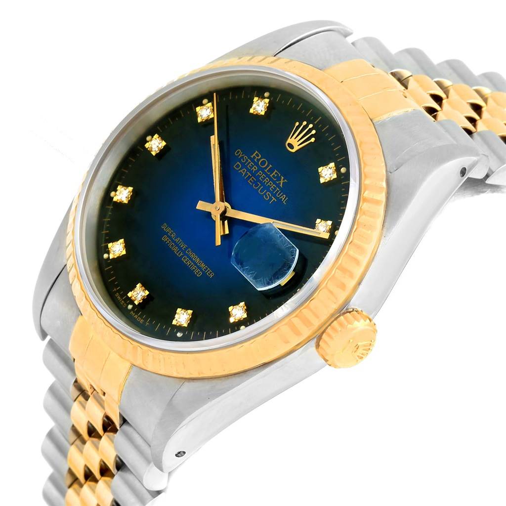 The image shows a Rolex Datejust 16233 Men's Steel and Gold (two tone) Blue Dial 16233 Men's Steel and Gold (two tone) Blue Dial watch at an angle, highlighting the blue dial, diamond hour markers, gold fluted bezel, and Jubilee bracelet.