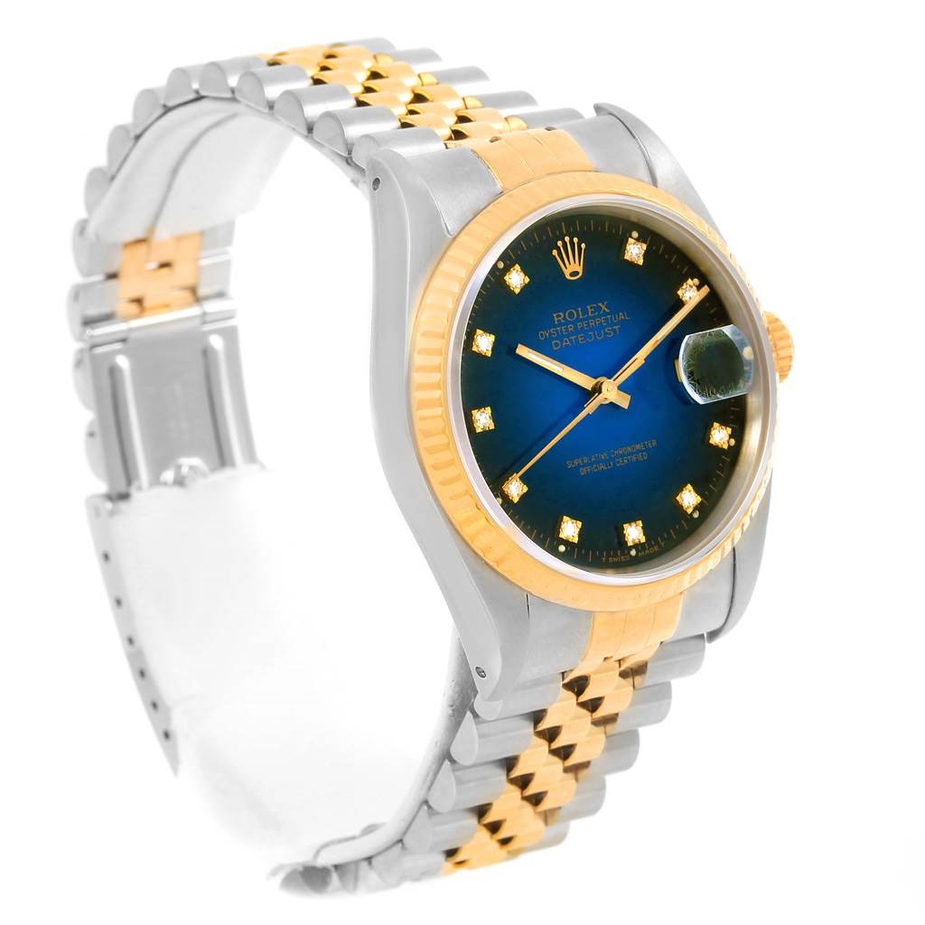 The image displays a Rolex Datejust 16233 Men's Steel and Gold (two tone) Blue Dial 16233 Men's Steel and Gold (two tone) Blue Dial watch angled to show its face, bracelet, and part of the clasp.