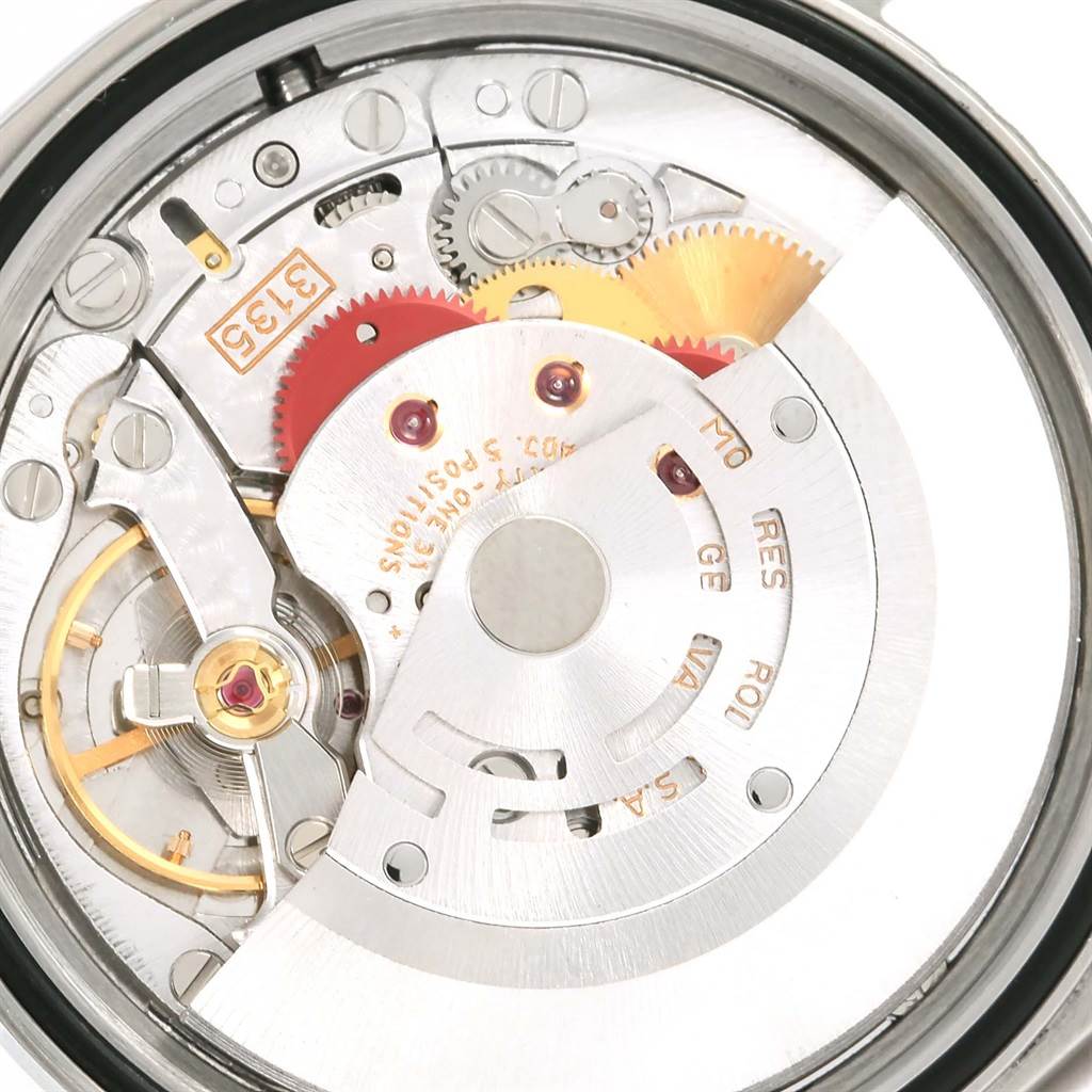 The image shows an interior view of the Rolex Datejust 16233 Men's Steel and Gold (two tone) Blue Dial 16233 Men's Steel and Gold (two tone) Blue Dial movement, exposing gears, cogs, and other intricate components.