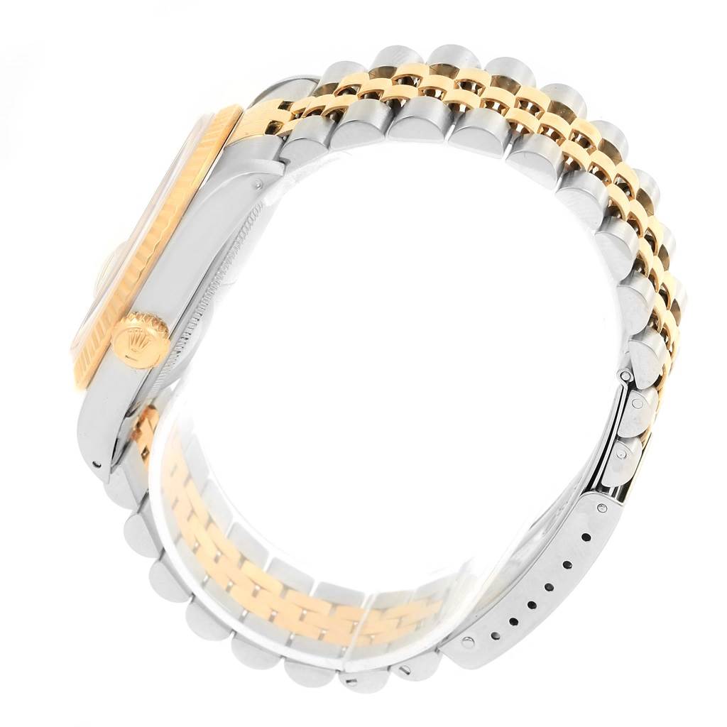 The image shows a side view of the Rolex Datejust 16233 Steel and Gold (two tone) Champagne Dial 16233 Steel and Gold (two tone) Champagne Dial watch, focusing on the crown, bezel, and two-tone bracelet.