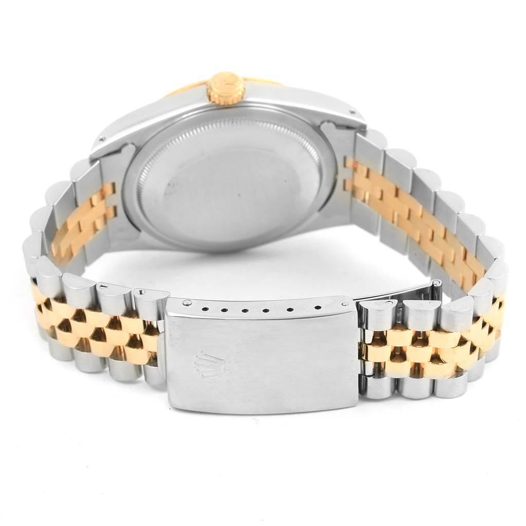 The image shows the back of a Rolex Datejust 16233 Steel and Gold (two tone) Champagne Dial 16233 Steel and Gold (two tone) Champagne Dial watch, highlighting its two-tone bracelet and partially opened clasp.