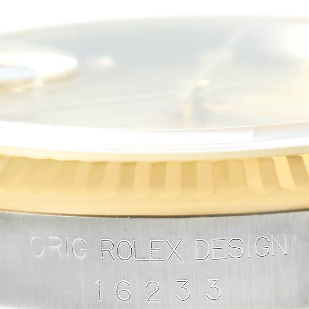 The image shows a close-up side view of a Rolex Datejust 16233 Steel and Gold (two tone) Champagne Dial 16233 Steel and Gold (two tone) Champagne Dial watch, focusing on the bezel and partially visible crystal.