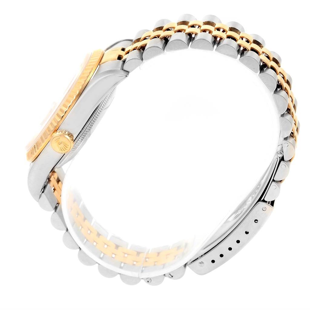 This image shows the side angle of a Rolex Datejust 16233 Steel and Gold (two tone) Champagne Dial 16233 Steel and Gold (two tone) Champagne Dial watch, featuring its crown, bezel, and two-tone bracelet.