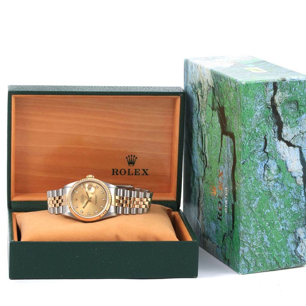 The image shows a Rolex Datejust 16233 Steel and Gold (two tone) Champagne Dial 16233 Steel and Gold (two tone) Champagne Dial watch with a gold and silver bracelet, displayed in an open green and wood-tone Rolex box, with the outer box next to it.