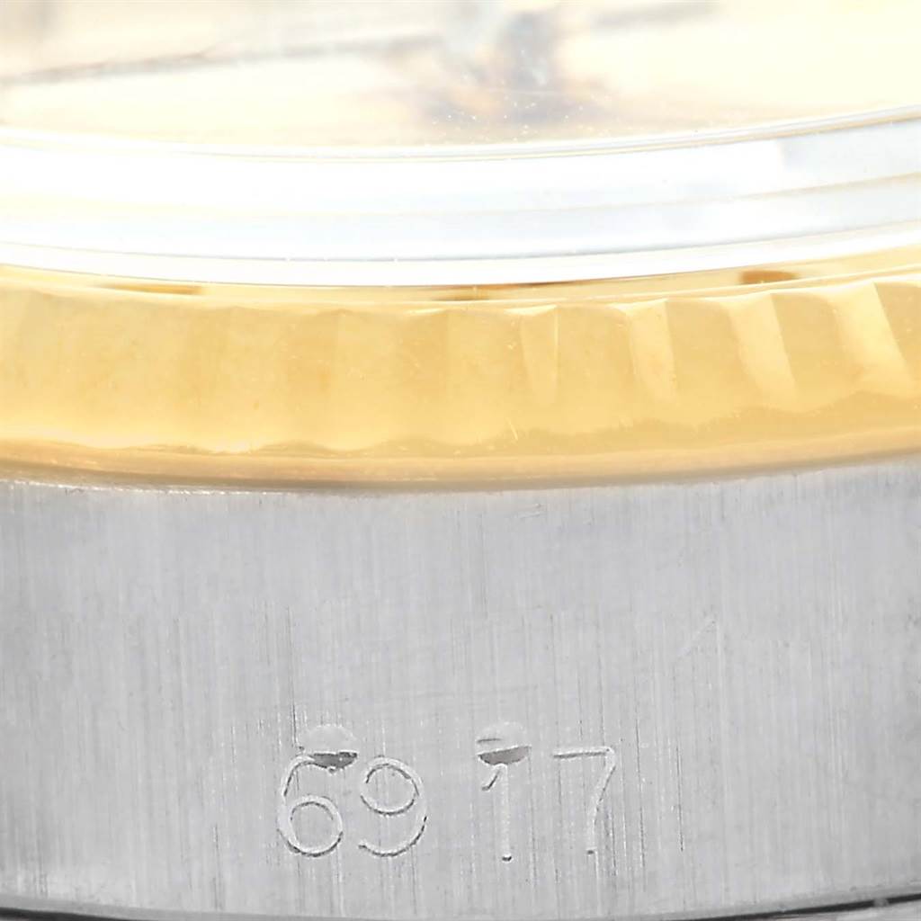 The image shows a close-up angle of the bezel and serial number on the case of a Rolex Datejust 6917 Women's Stainless Steel Champagne Dial 6917 Women's Stainless Steel Champagne Dial watch.