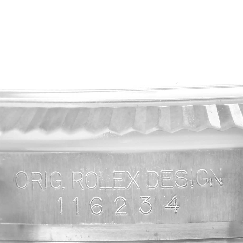 This close-up shows the model number and fluted bezel of the Rolex Datejust 116234 Stainless Steel Pink Dial 116234 Stainless Steel Pink Dial.