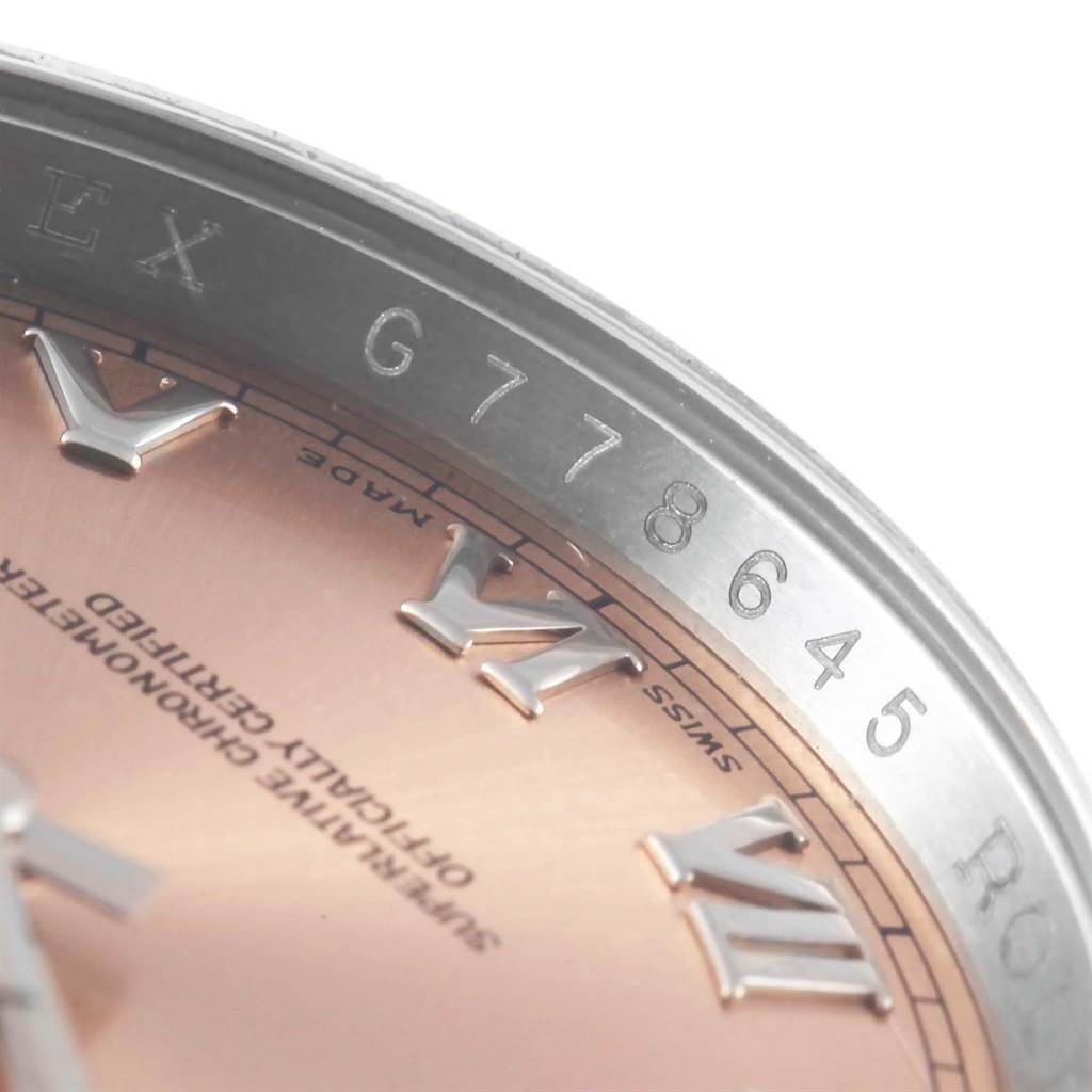 The image shows a close-up of the dial and rehaut with engraved serial number (G778645) of a Rolex Datejust 116234 Stainless Steel Pink Dial 116234 Stainless Steel Pink Dial watch.